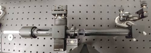 Figure 9: Picture of the assembled compact interferometer, which is mounted in front of a flat mirror visible in the top-right.